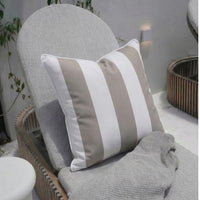 Beige stripe Outdoor Pillow styled in a poolside setting