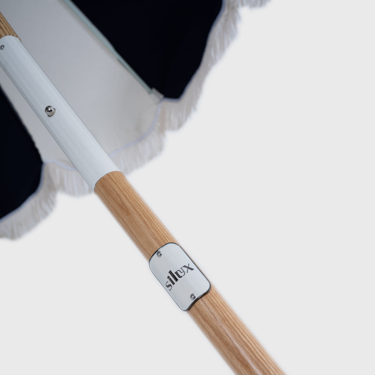 Silux badge and rib detail on the Mentari Market Umbrella in Dark Navy