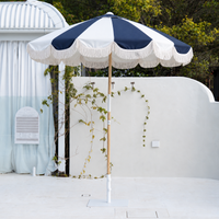 Mentari Market Umbrella in Dark Navy and oat by the pool