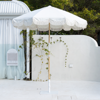 Mentari Market Umbrella in solid Oat by the pool