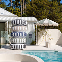 Stack of Halo Float V2 pool floats in navy, charcoal, beige, black and sage stripes