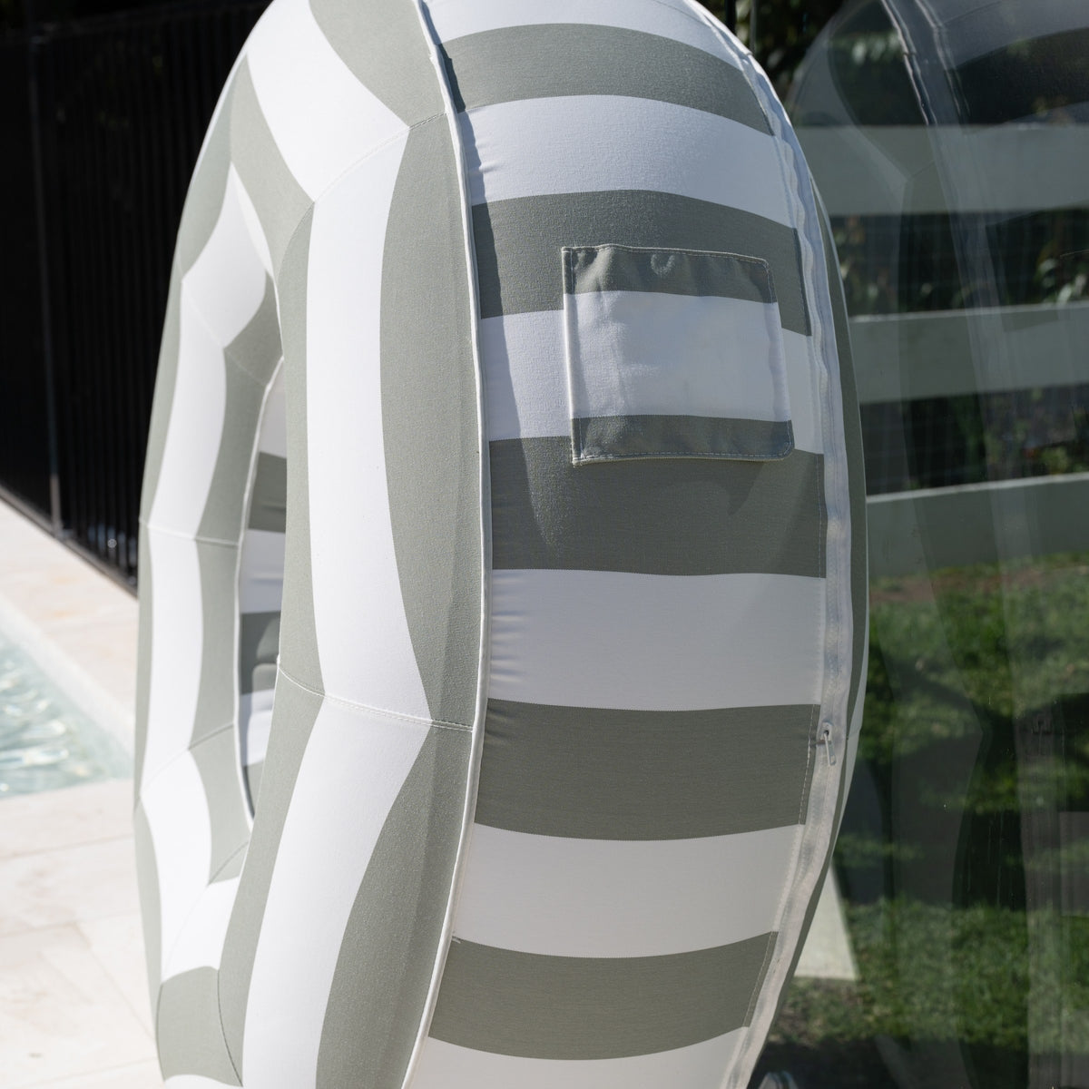Side close-up of the sage and white striped Halo Float V2 showing the pocket